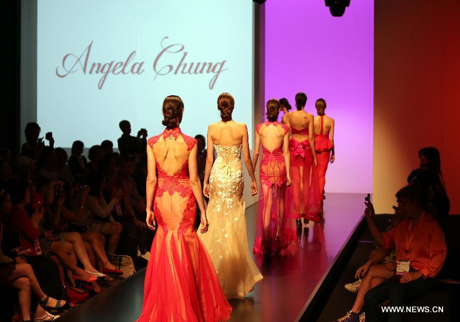 Models present creations at the 20th Hong Kong Fashion Week for Spring/Summer in south China's Hong Kong, July 10, 2013. The four-day fair, which is organized by the Hong Kong Trade Development Council, kicked off at the Hong Kong Convention and Exhibition Center Monday. (Xinhua/Li Peng)