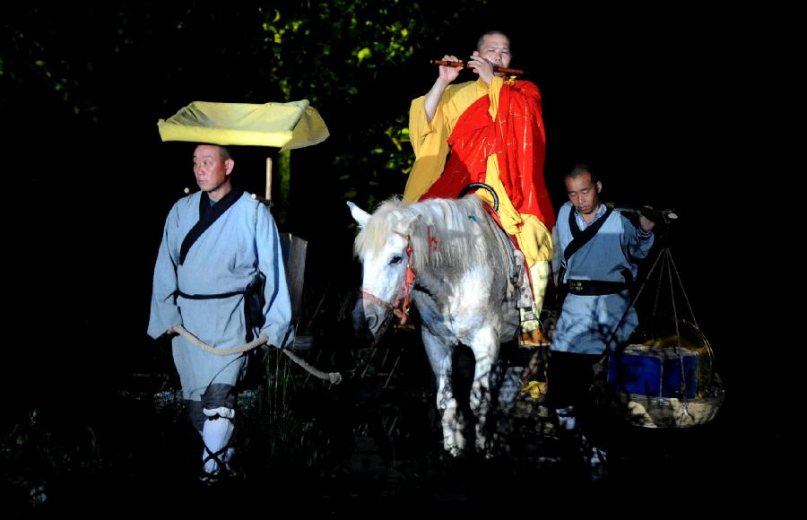 Actors perform in the music ritual in Zhengzhou, capital of central China's Henan Province, July 14, 2013. The real scene show "Shaolin Zen Music Ritual" has run for more than 1,600 performances since its premiere in May, 2007. The music ritual was shown on the natural stage of the Songshan Mountain to present a rhythm combined with natural sounds and the "Zen Music". (Xinhua/Zhu Xiang) 