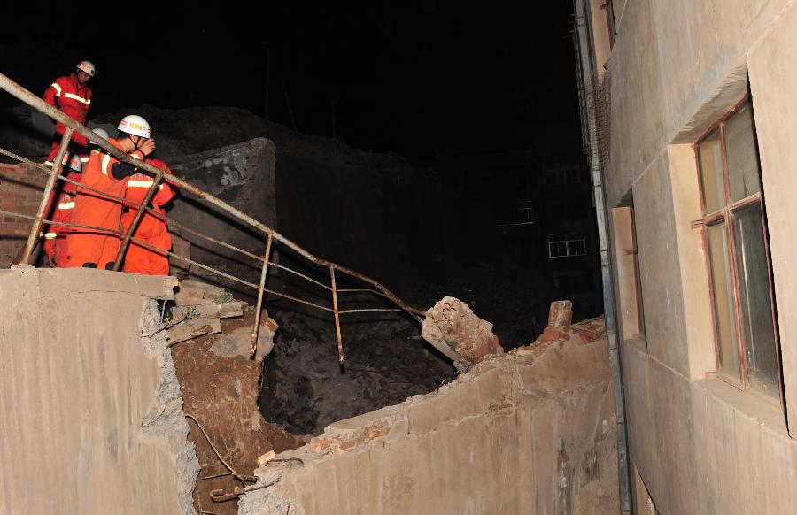 Rescuers work at the landslide site in Chengguan District of Lanzhou City, northwest China's Gansu Province, July 15, 2013. Two landslides happened in Lanzhou on Monday due to the continuous rainfalls, leaving dozens people trapped. The rescue work is underway. (Xinhua/Liang Qiang)