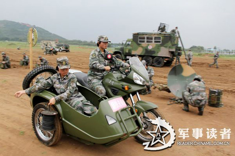 Female soldiers in a communication detachment of a brigade under the Jinan Military Area Command (MAC) of the Chinese People's Liberation Army (PLA) are in a communication exercises in a field training ground in mid July.  (China Military Online/Yu Hualiang, Yan Xiaohui, Jiang Honglin) 