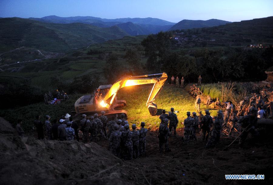 A rescue team of the Lanzhou Military Area Command excavates a mud-covered cellar for possible survivors at Yongguang Village in Meichuan Town of Minxian County, northwest China's Gansu Province, July 22, 2013. The death toll has climbed to 89 in an earthquake that hit the border of Minxian County and Zhangxian County in the city of Dingxi Monday morning, local authorities said. (Xinhua/Luo Xiaoguang)