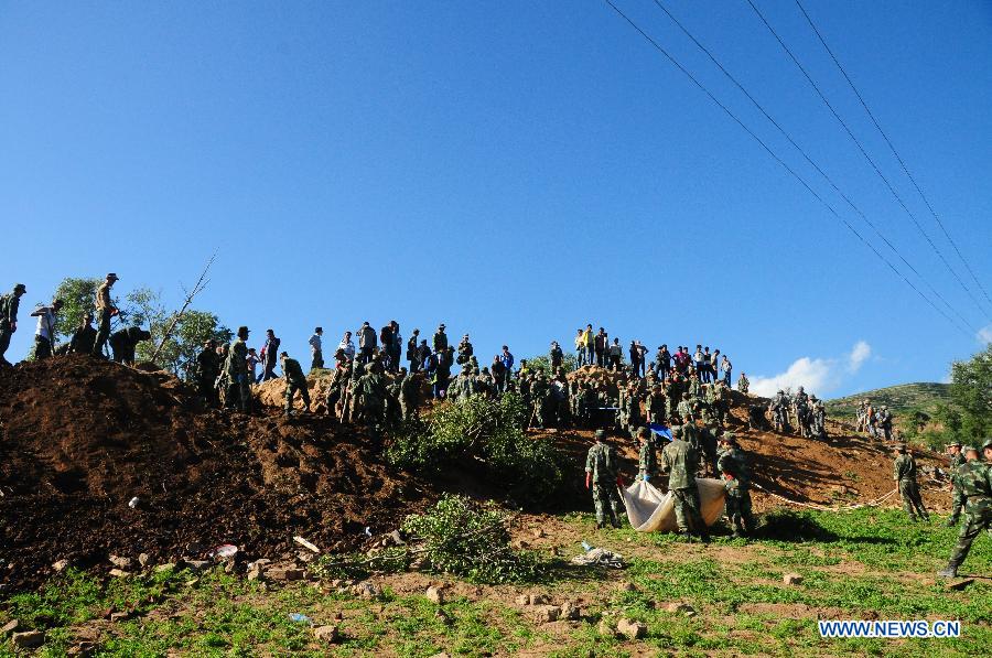 Soldiers take part in a rescue operation after a landslide triggered by a 6.6-magnitude quake in Yongguang Village, Meichuan Town, Minxian County, northwest China's Gansu Province, July 22, 2013. At least nine villagers in Yongguang were killed in the quake and 12 others were burried in the landslide. The rescue work is underway. (Xinhua/Tu Guoxi)