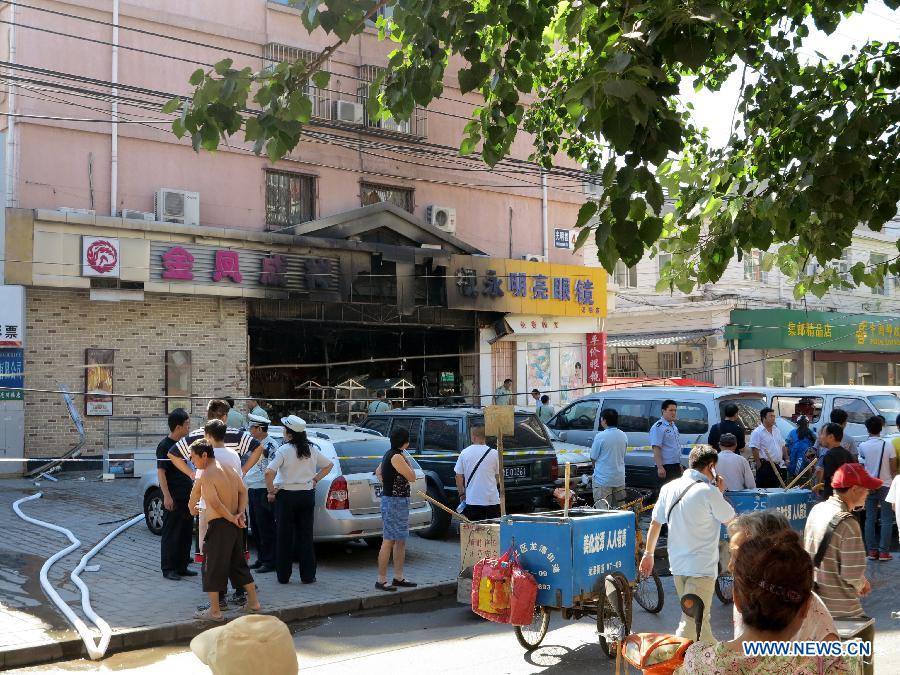 Firemen work at the explosion site of a cake shop on Guangming Road in Beijing, capital of China, July 24, 2013. A gas blast ripped through the cake shop Wednesday morning, leaving a number of people injured and vehicles damaged. (Xinhua/Wang Zhen)