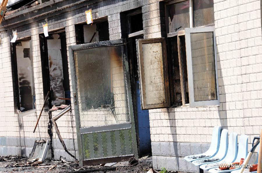 Photo taken on July 26, 2013 shows the accident site at the Lianhe Senior Nursing Home where a fire took place in Hailun City, northeast China's Heilongjiang Province. Eleven people were killed in the fire that occurred early Friday. Local police said arson has been confirmed as the cause of the fire. A total of 283 elderly people were living in the nursing home, which was built in October 2005. With an area of 7,000 square meters, it caters for the rural elderly in the city who have no source of income. (Xinhua/Wang Song)