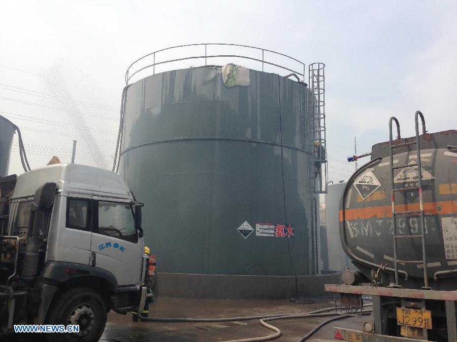 Fire engines are seen at the site of ammonia storage tank leakage at a chemical plant in Taixing City, east China's Jiangsu Province, July 26, 2013. A leakage was found at the 300-ton tank of Yichu Chemical Co., Ltd. at 7 a.m. Friday, leaving several people poisoned. Rescuers have taken emergency measures to stop the leak. (Xinhua/Yang Hai) 