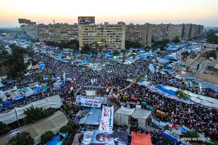 Supporters of Egypt's ousted President Mohamed Morsi take part in a protest in Rabaa Al-Adaweya Square for the 29th day in row, Cairo, July 26, 2013. A top Egyptian court has ordered the detention of ousted Islamist-oriented President Mohamed Morsi for 15 days for investigations over charges of spying and jailbreak, official media reported Friday. (Xinhua/Amru Salahuddien) 