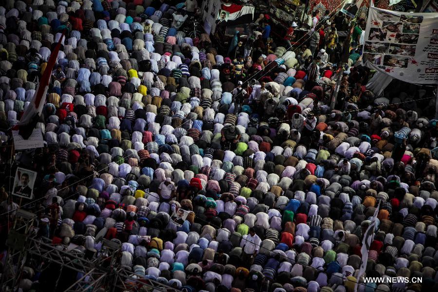 Supporters of Egypt's ousted President Mohamed Morsi pray during a protest in Rabaa Al-Adaweya Square for the 29th day in row, Cairo, July 26, 2013. A top Egyptian court has ordered the detention of ousted Islamist-oriented President Mohamed Morsi for 15 days for investigations over charges of spying and jailbreak, official media reported Friday. (Xinhua/Amru Salahuddien) 