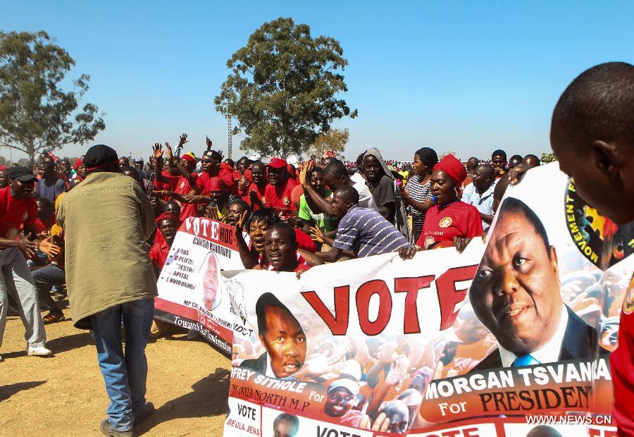 People gather at a campaign rally of presidential election candidate Morgan Tsvangirai in Chitungwiza of Harare, capital of Zimbabwe, July 28, 2013. Zimbabweans are expected to vote on July 31 to choose a president, legislators, and local councilors. Incumbent President Robert Mugabe and Prime Minister Morgan Tsvangirai are considered the main contenders for the presidency. (Xinhua/Meng Chenguang) 